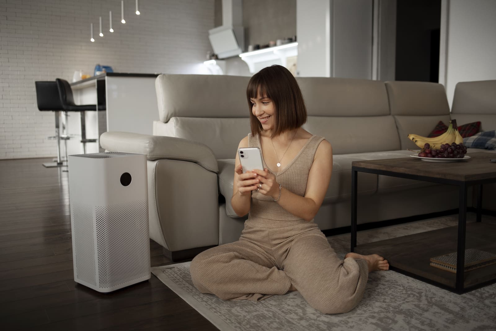 Portrait of a woman using a room purifier, which is a hotel amenity for an increased comfort.