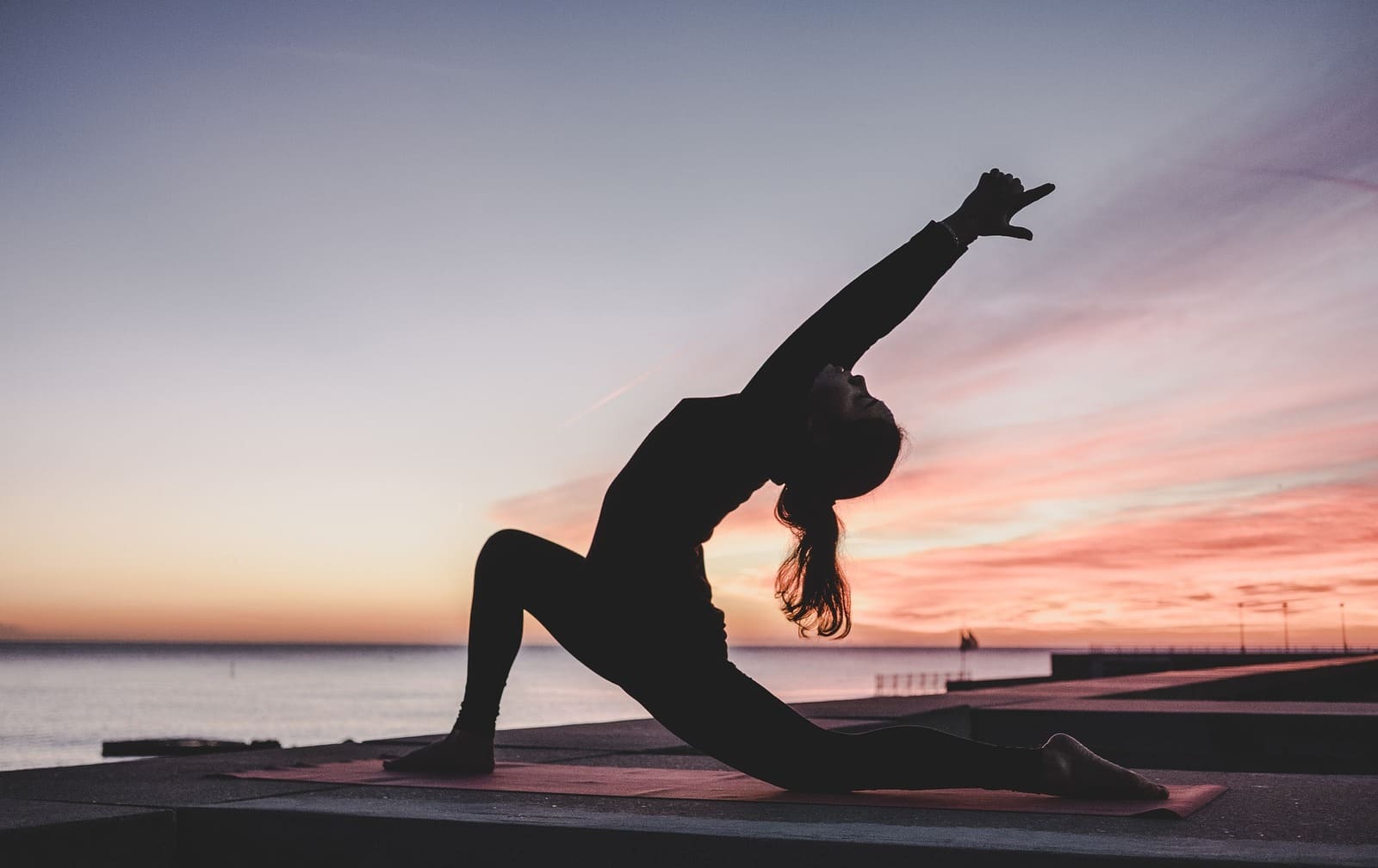 Photograph of a beach yoga activity, one of the popular hotel room amenities.