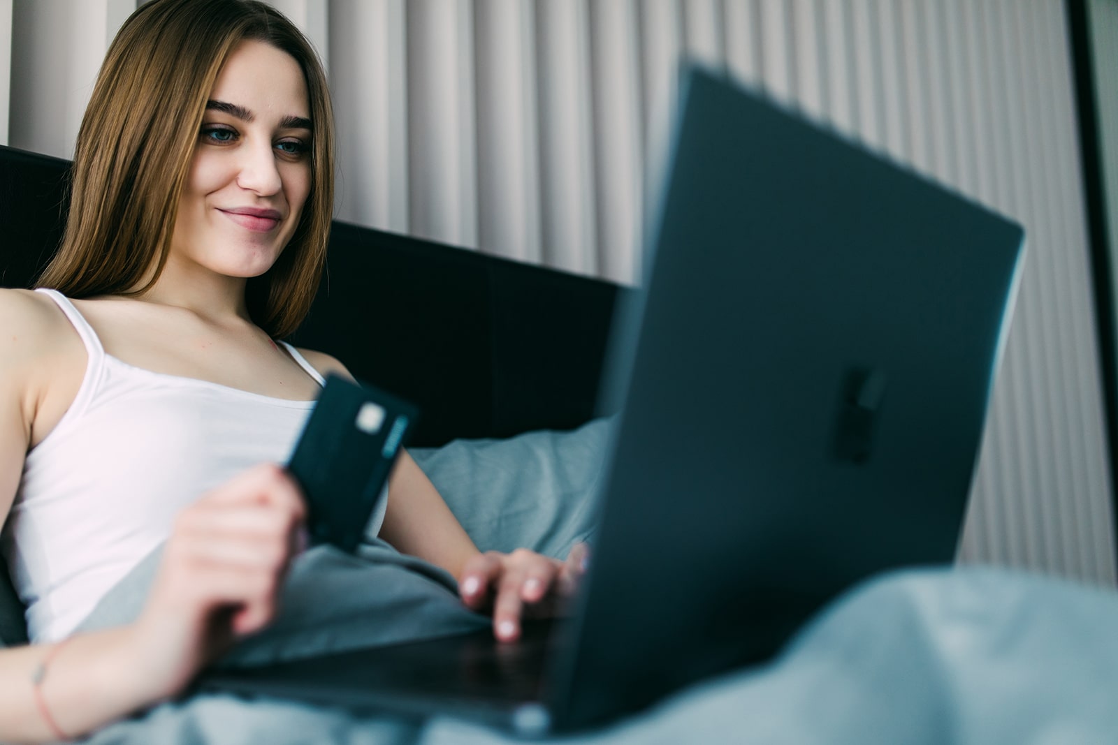 Photograph of a woman paying online for an appointment.