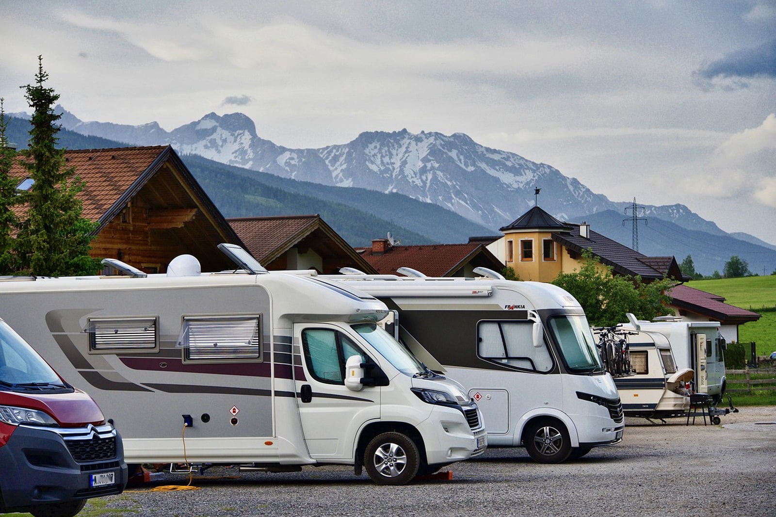 Image of recreational vehicles parked near a campsite.