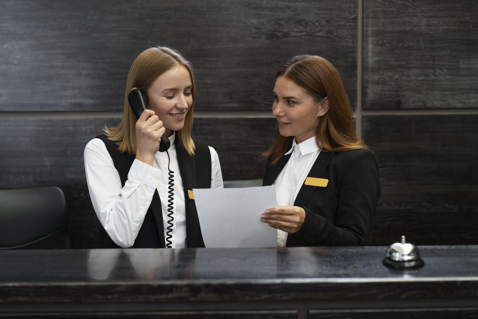 Snapshot of two receptionists dealing with booking cancellations over the phone.