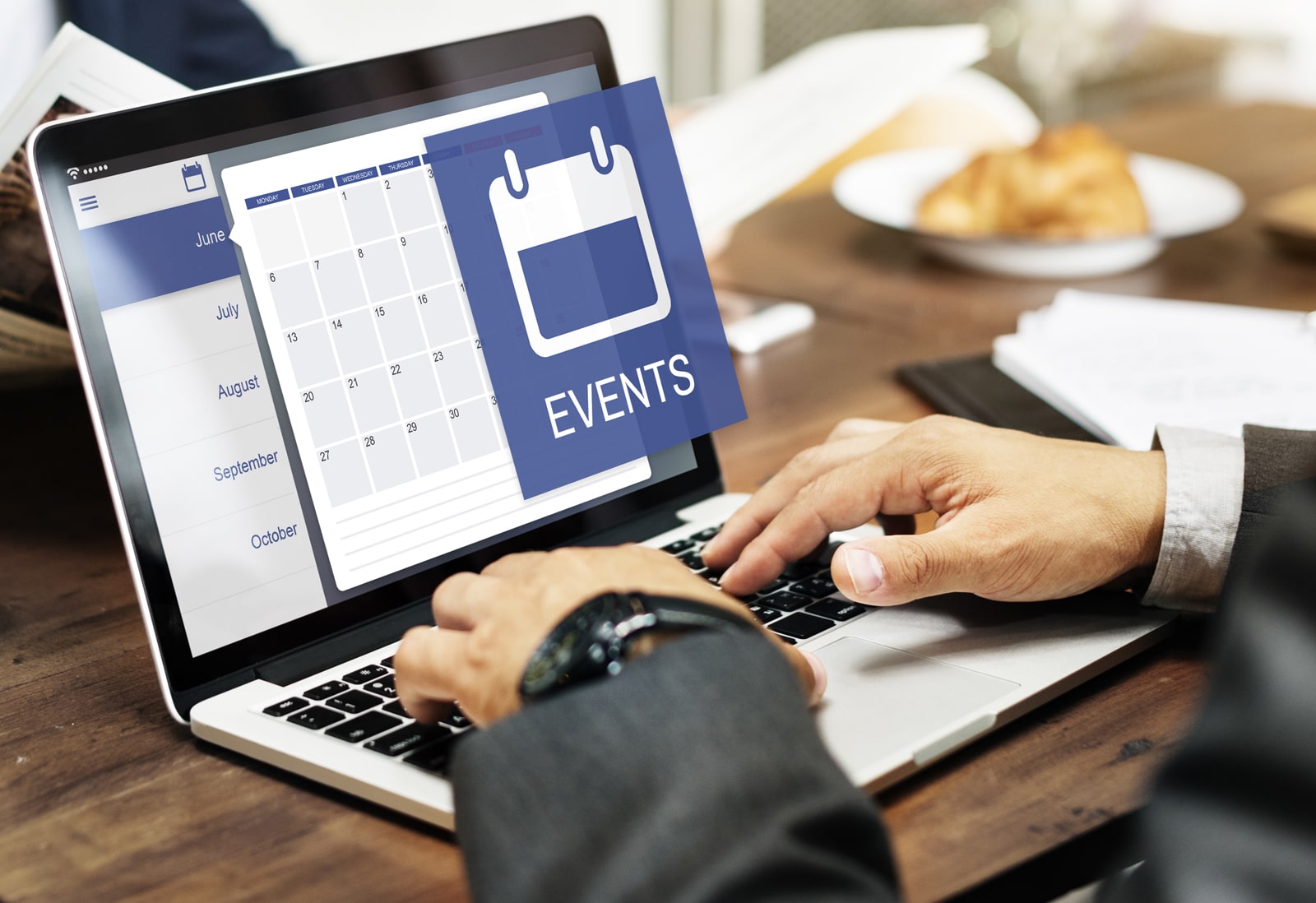 Image of managing an online calendar using a laptop.