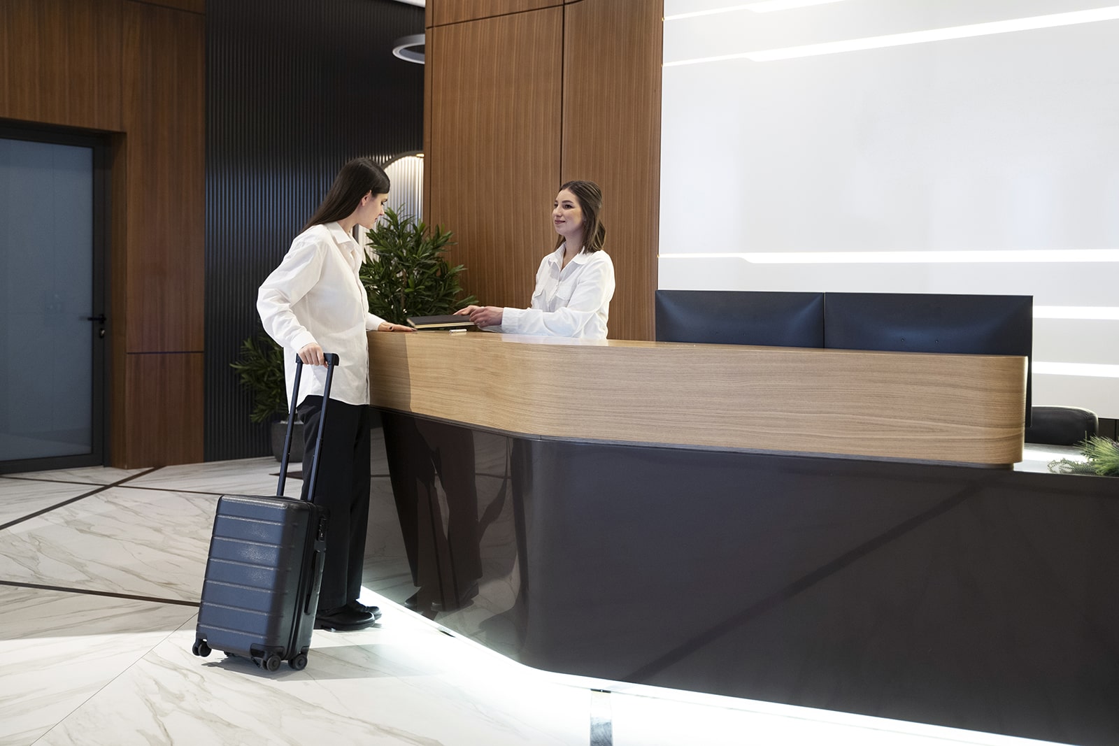 View of a woman booking accommodation on a nightly basis, which can be implemented by a WordPress availability calendar plugin.
