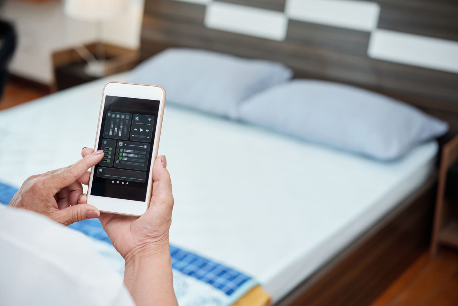 Graphic of a person holding a mobile phone when using a bed and breakfast website design.